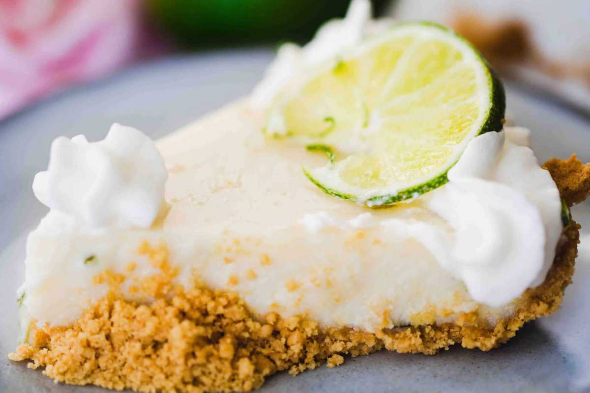 Slice of Key Lime pie sits on a plate ready to enjoy.