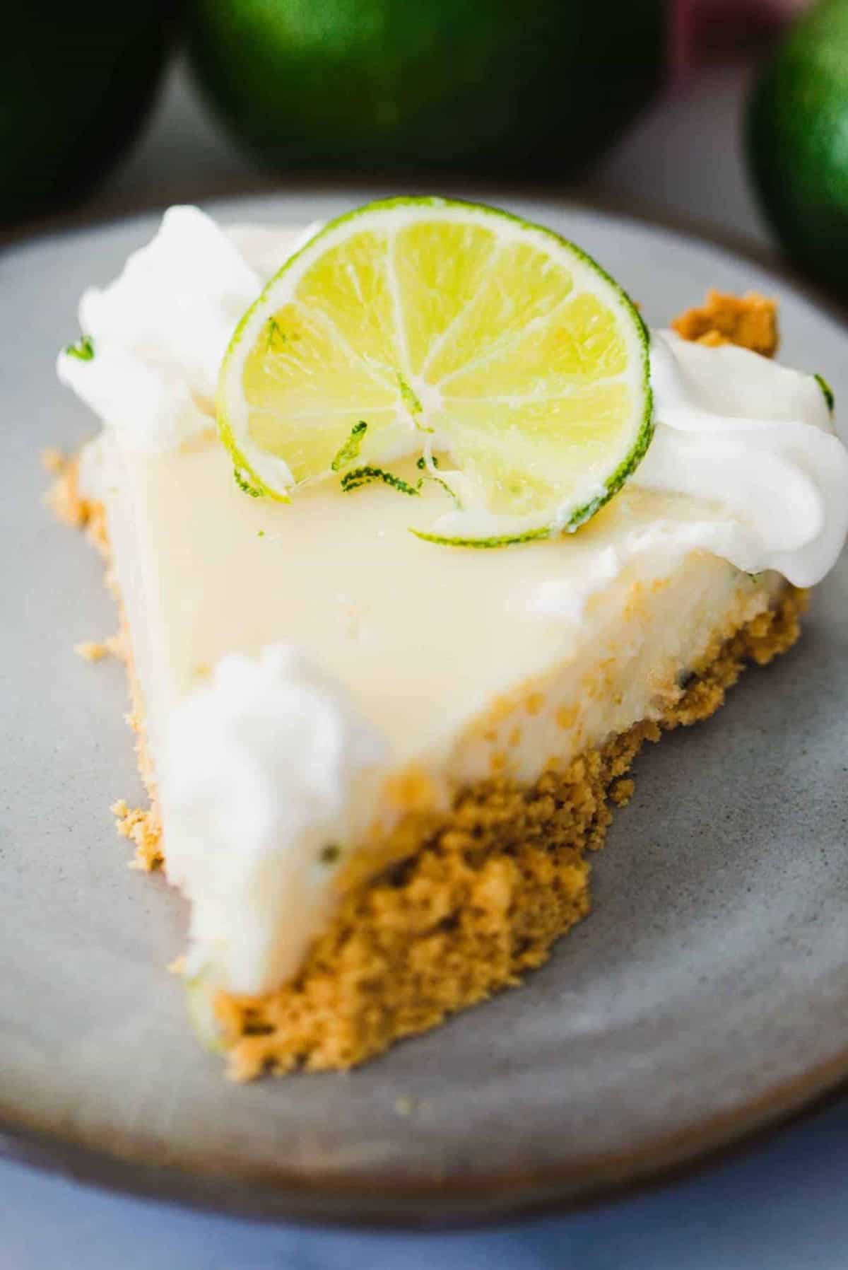 Slice of Key Lime pie sits on a plate ready to enjoy.