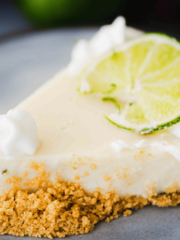 Slice of Key Lime pie sits on a plate ready to enjoy.