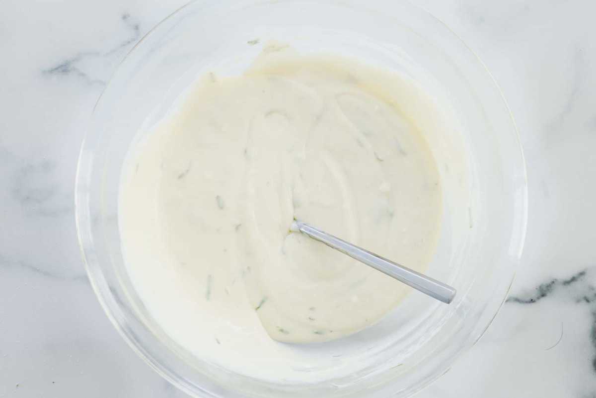 Filling for key lime pie sits in a glass bowl ready to go in a pie tin.