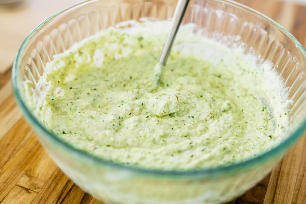 Pesto Ricotta sits in a glass bowl.