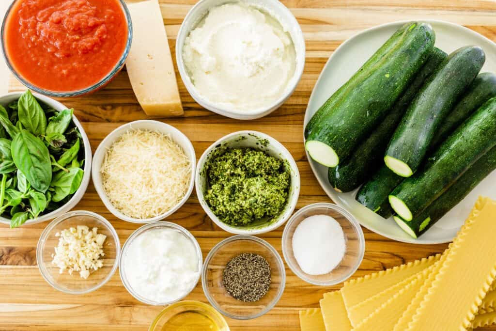 Ingredients for Zucchini and Pesto Lasagna it out on a countertop ready to be used.