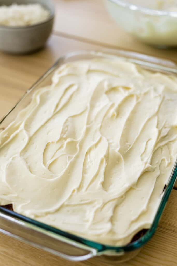 9x13 glass casserole dish sits on the counter inside is an iced cake.