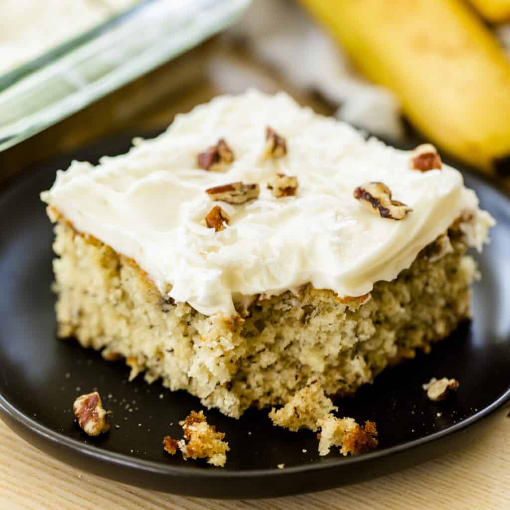 Piece of banana cake sits on a plate ready to enjoy.