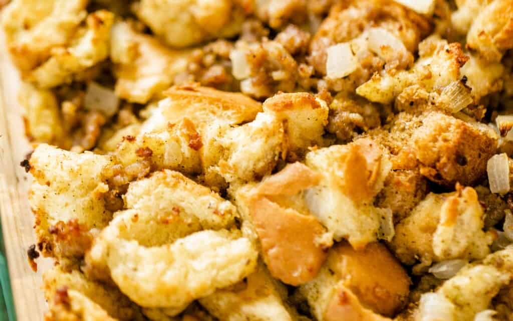 Freshly cooked sausage stuffing sits in a casserole dish ready to enjoy.