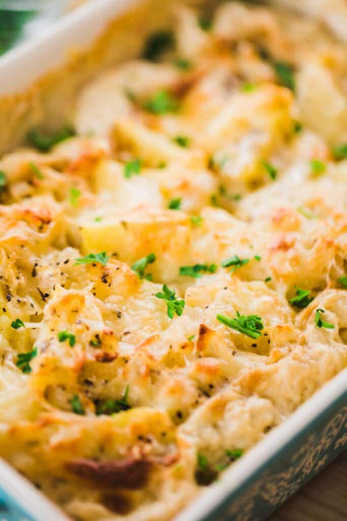 Golden brown, perfectly tender Au Gratin potatoes sit in a casserole dish.