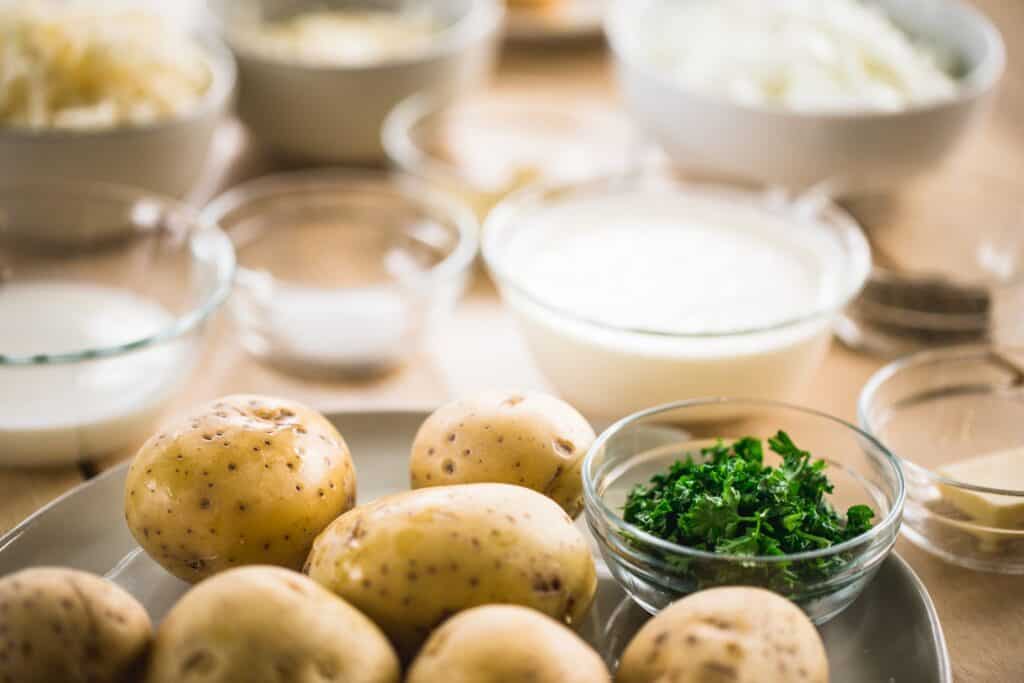 Ingredients for Au Gratin potatoes sit portioned on the counter ready to combine.