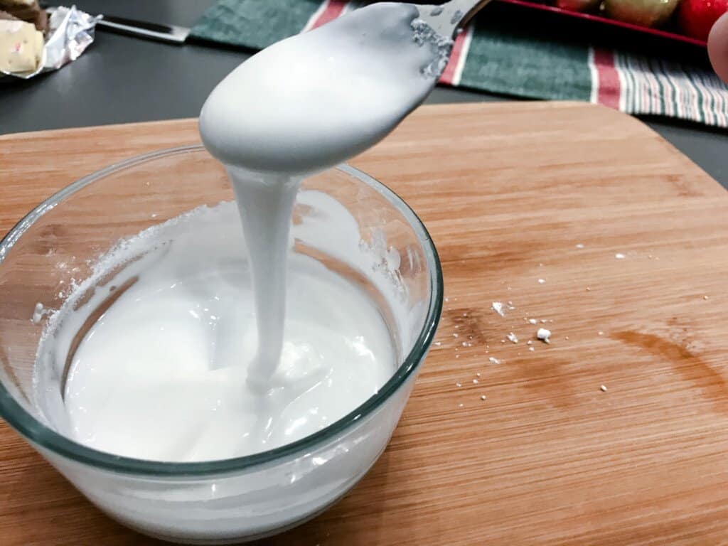 Royal Icing sits in a bowl to be used as concrete for house making.