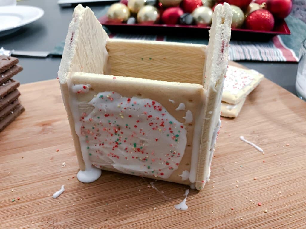 Pop Tarts are held together by royal icing to make the base house structure.