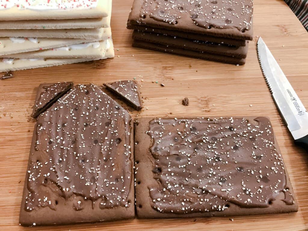 Two pop tarts are positioned next to one another ready to be cut into shape for making houses.