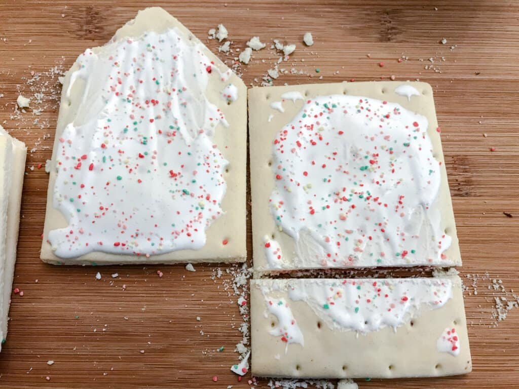 Two pop tarts are positioned next to one another ready to be cut into shape for making houses.