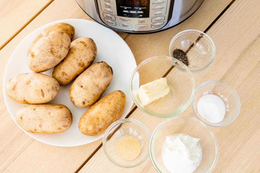 Ingredients for quick Mashed Potatoes sit in front of an Instant Pot ready to be used in a recipe.