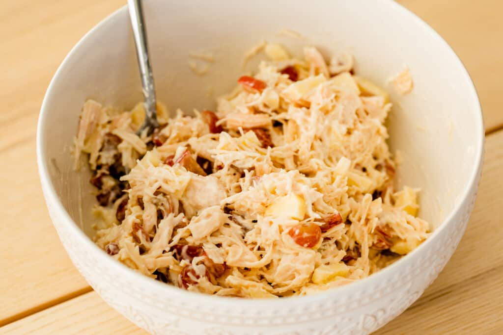 Chicken Salad ingredients are combined in a bowl.