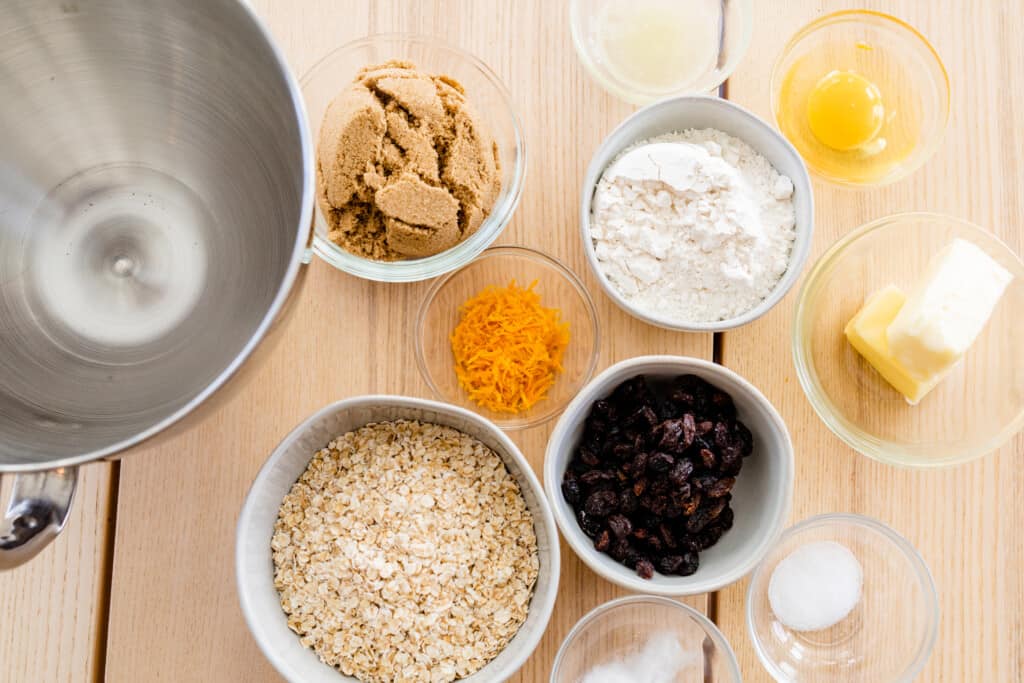 All the ingredients for cookies sit alongside an empty kitchen aid mixer.