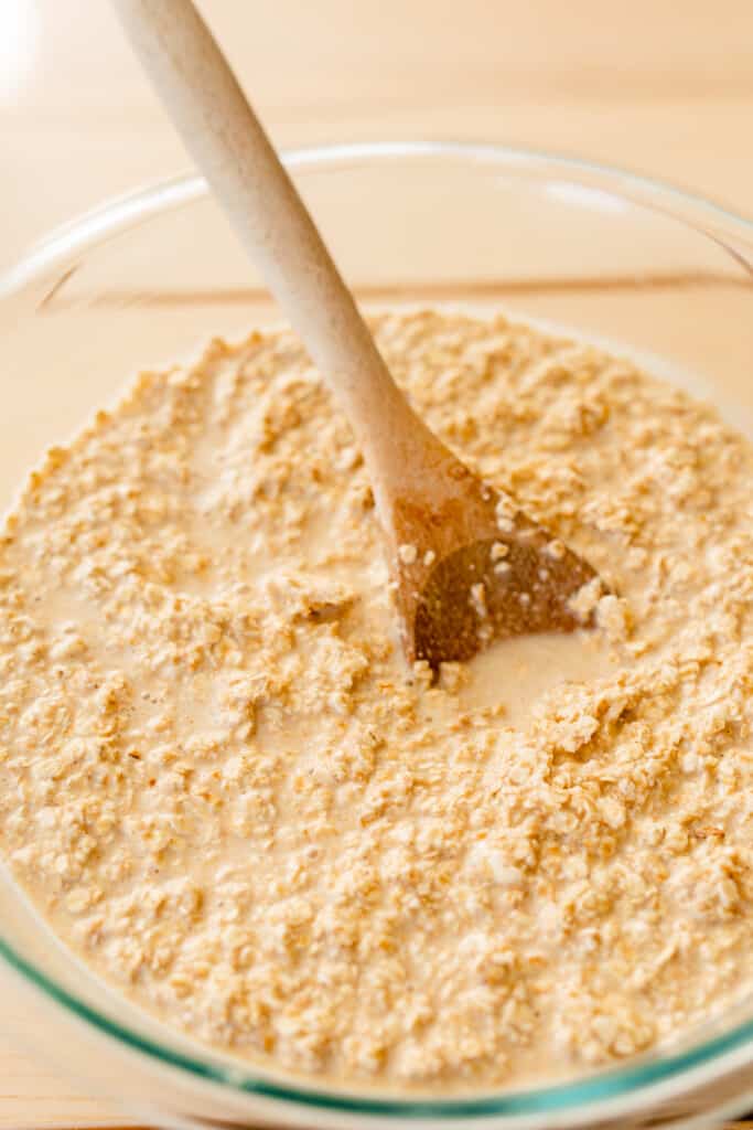 The first set of ingredients of oatmeal batter are mixed together and in a glass bowl.