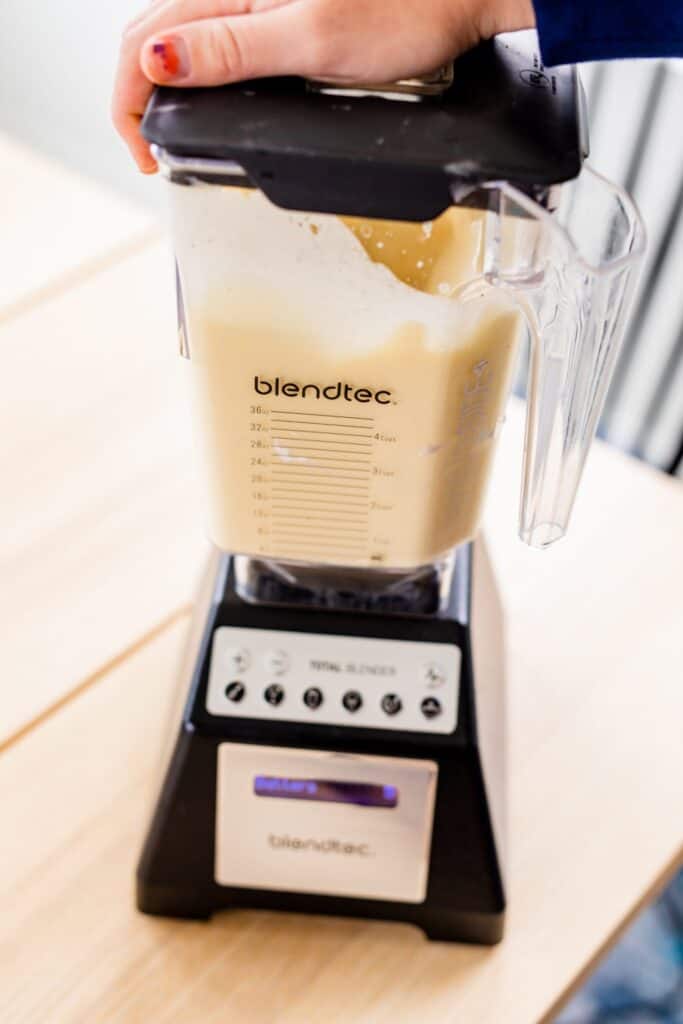 Ingredients for German Pancakes are being mixed together inside a Blendtec blender.