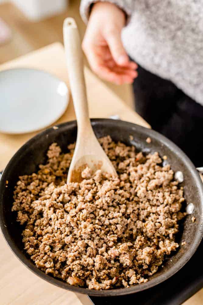 Hot sausage sits in a skillet, cooked and ready to be used.