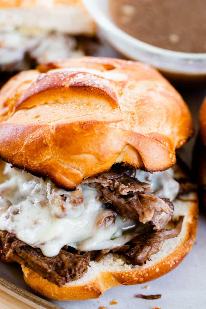 A bun is stacked high with tender shredded beef and melty cheese as a super bowl food option.