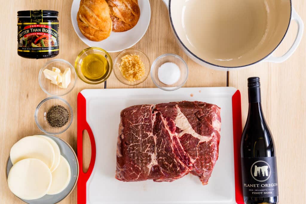All the ingredients for French Dip sandwiches sit on the tabletop.