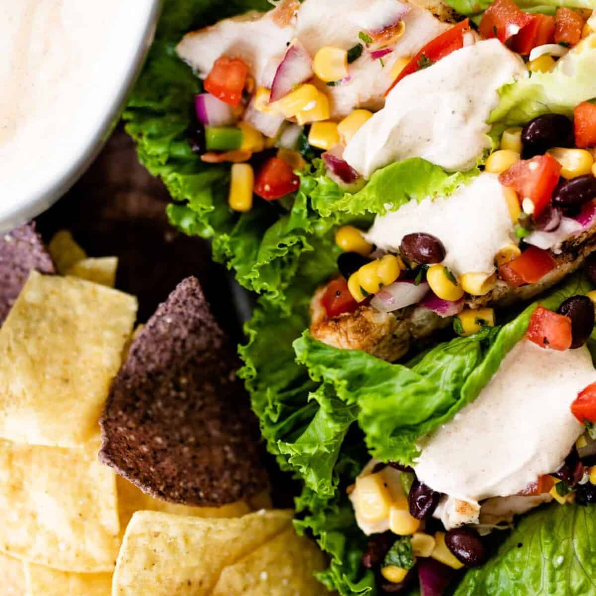 Southwest wraps sit on a bed of crisp tortilla chips ready to serve.