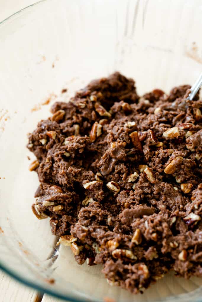 Chopped pecans are mixed in to the brownie batter dough.