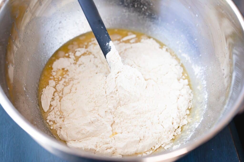 Two cups of flour have been added to milk mixture for rolls.