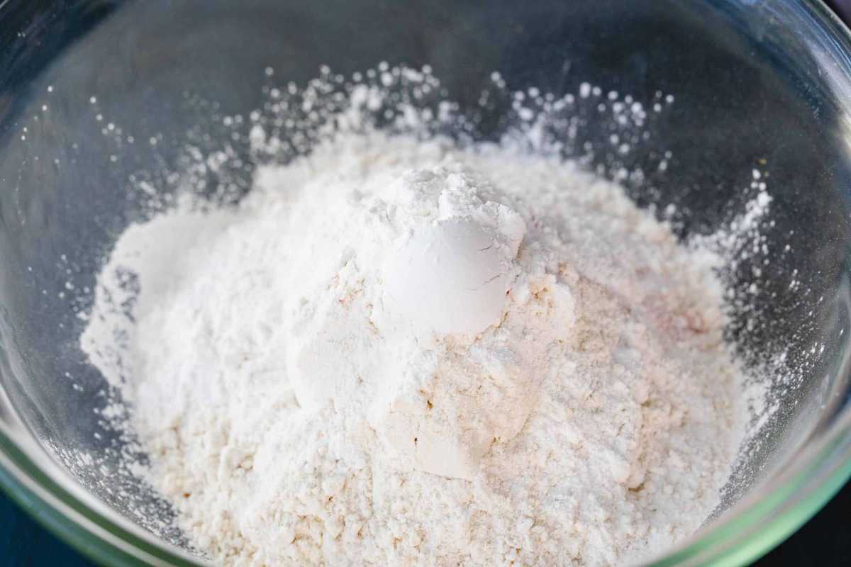 Dry ingredients for waffles sit in a glass bowl.