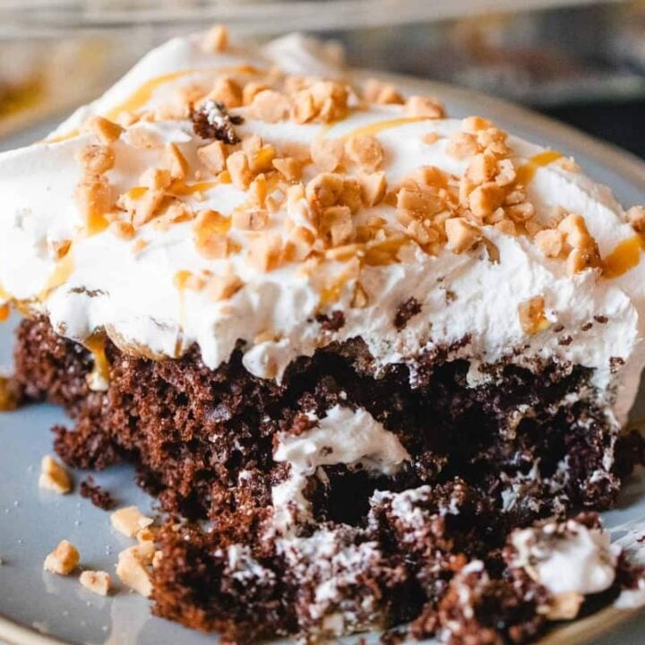 Slice of heath bar cake sits on a plate ready to enjoy.