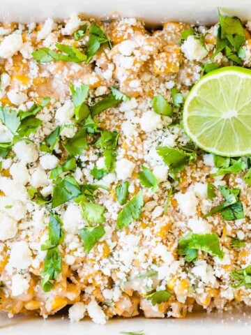 Mexican Street Corn Elote Salad is topped with fresh limes and cilantro.