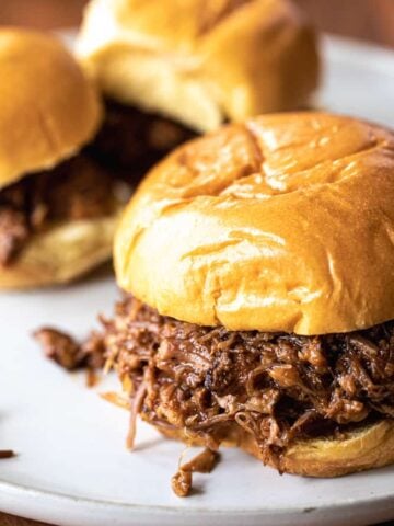 Savory bbq pulled pork sits on golden buns ready to serve up and enjoy.