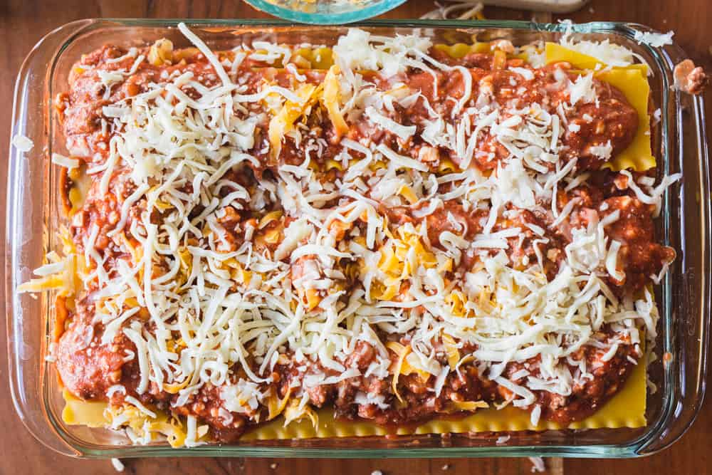Layered and assembled easy lasagna with cottage cheese sits in a glass baking dish, ready to go in the oven.