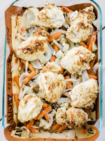 One pan parmesan chicken and roasted veggies sits in a baking dish ready to be served and enjoyed.