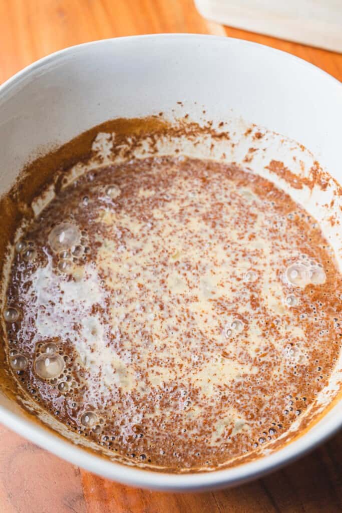 A sweet cinnamon egg mixture sits in a large white bowl.