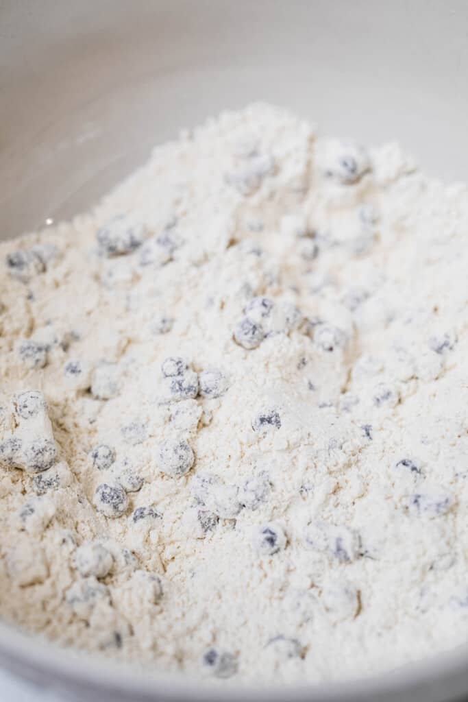 Blueberries tossed in a flour mixture are coated and ready for the wet ingredients.