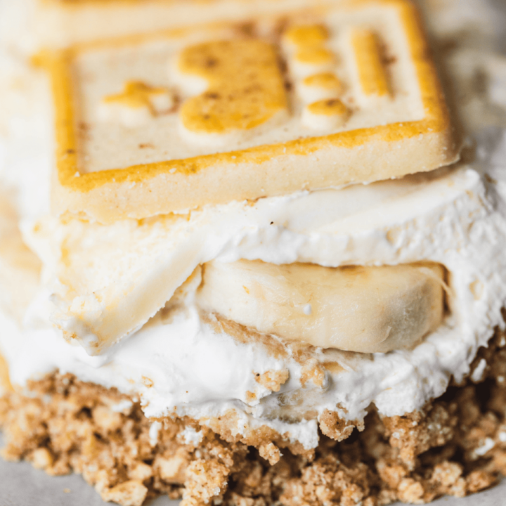 Layers of Chessmen Banana Pudding sit on a plate ready to eat and enjoy.