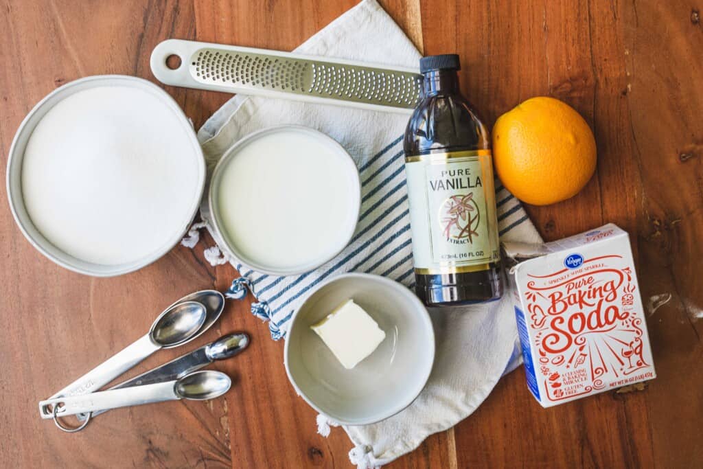 Ingredients and tools for making syrup sit on a wooden counter top.