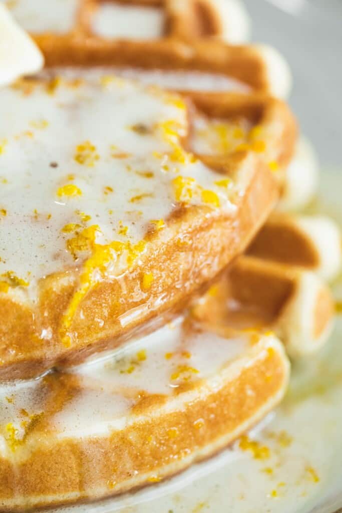 Waffles slathered in warm Orange Blonde Butter Syrup sit on a plate