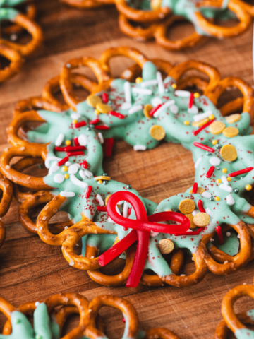 Decorated holiday pretzel wreath lay on a wooden table top.