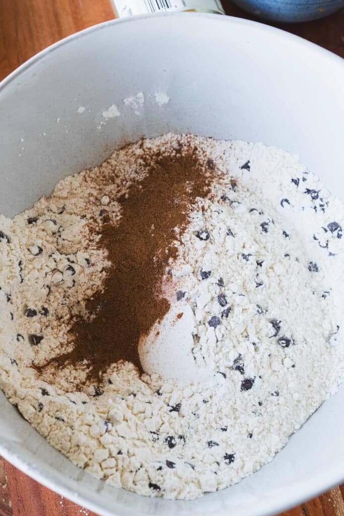 Dry ingredients sit in a large white bowl for mixing.