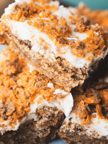 Butterfinger Blondies are cut into bars and stacked for serving.