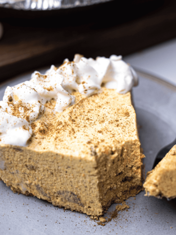 Slice of pie sits on plate with forkful of Pumpkin Marshmallow Pie.