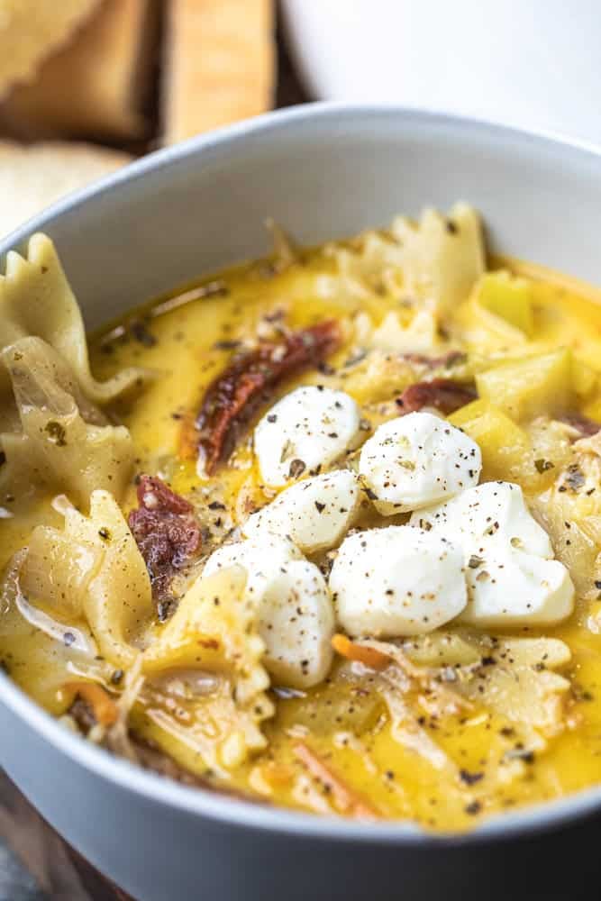 Bowl of creamy white lasagna soup is served up in a bowl for enjoying.