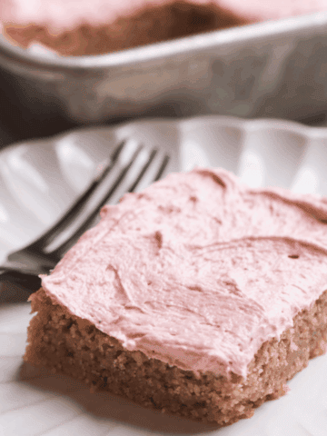 Piece of Strawberry Sheet Cake served on plate with fork.