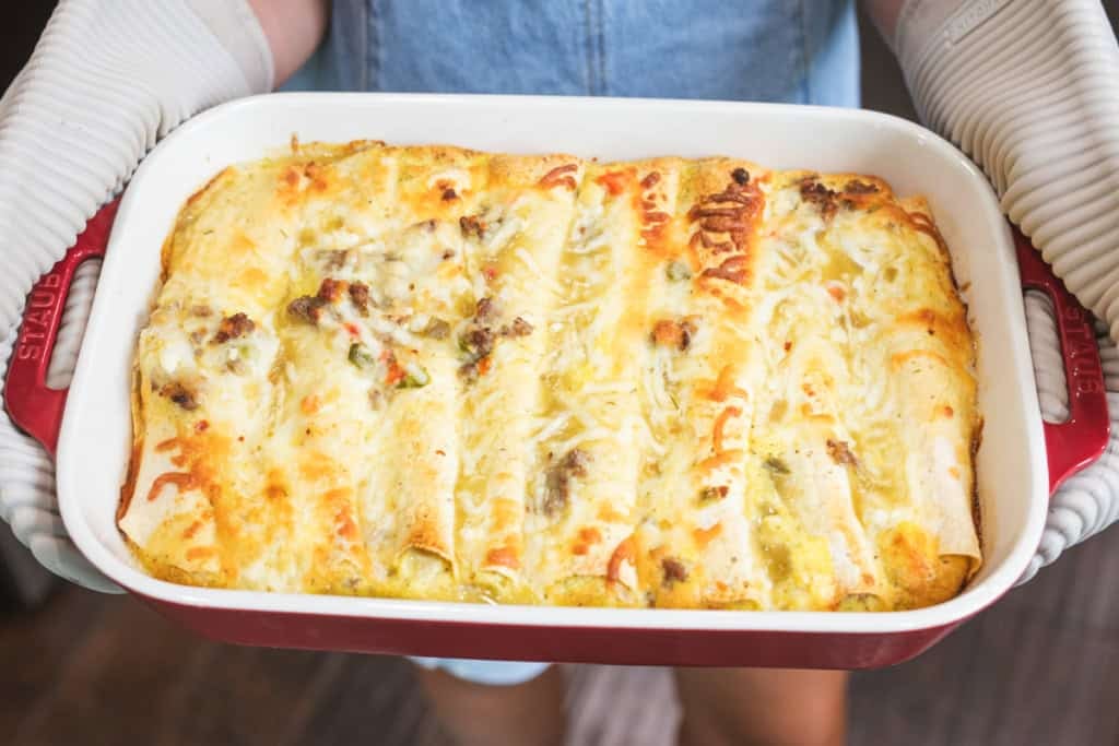 Cheesy and golden brown a pan of breakfast enchiladas are pulled from the oven ready to enjoy.